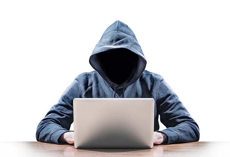 Hooded individual using computer